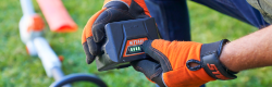Image of a person holding a stihl battery