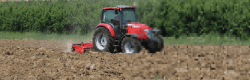 McCormick tractor working in a mud field, half of the image is pixalated